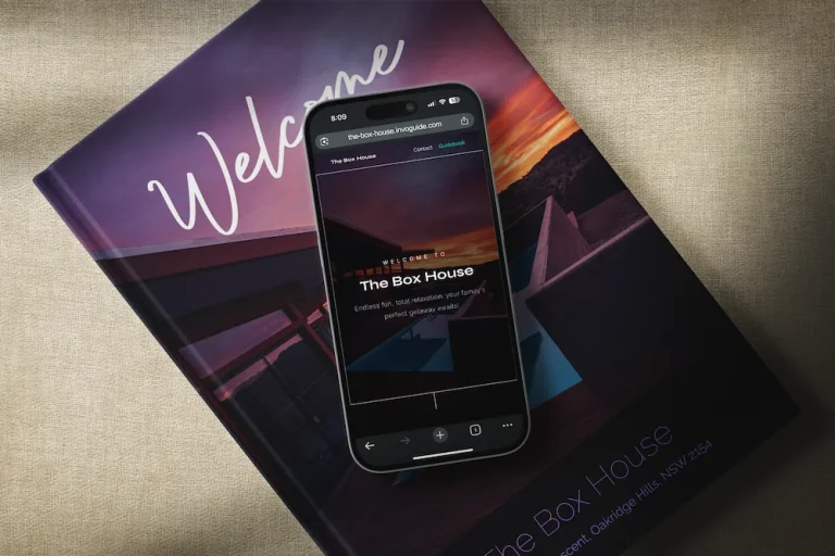 a cell phone with a digital guidebook displayed in it, placed on top of a physical guidebook