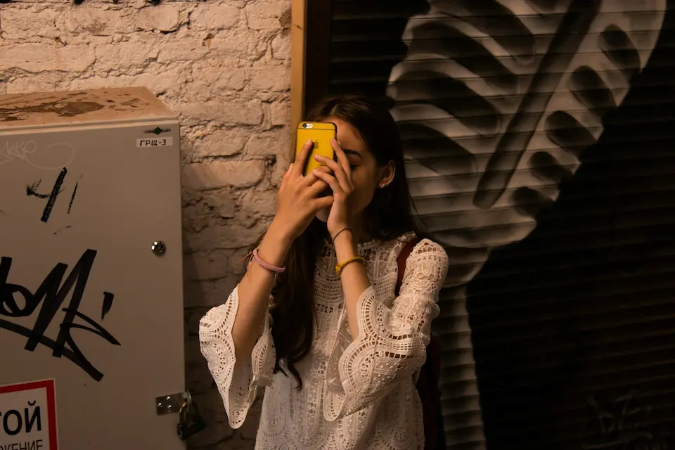 InvoGuide: Digital guidebooks for Airbnbs or vacation rental properties a woman holding a phone to her face, looking lost
