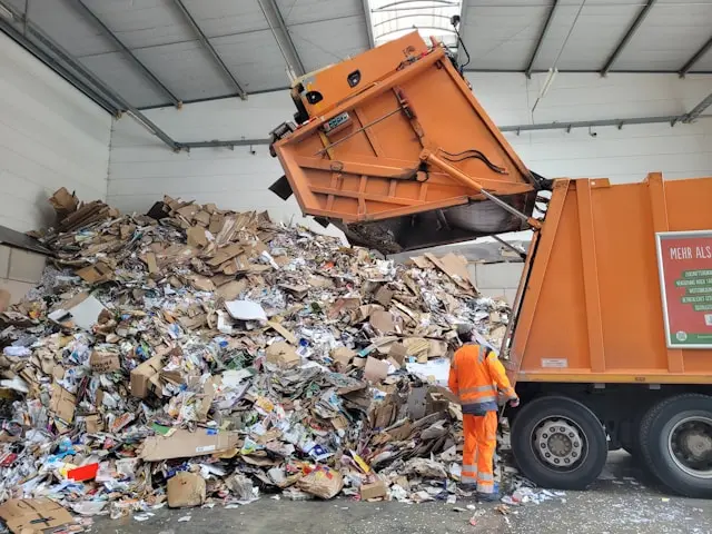 InvoGuide: Digital guidebooks for Airbnbs or vacation rental properties a man standing next to a garbage truck